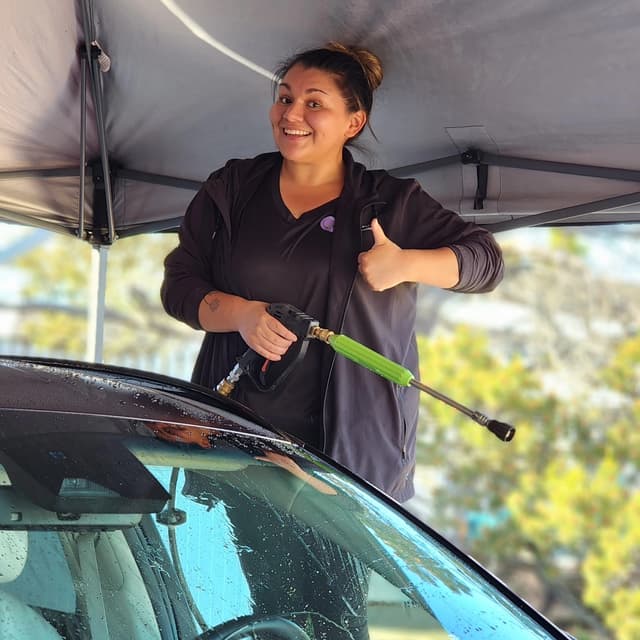 Isabela giving thumbs up while cleaning